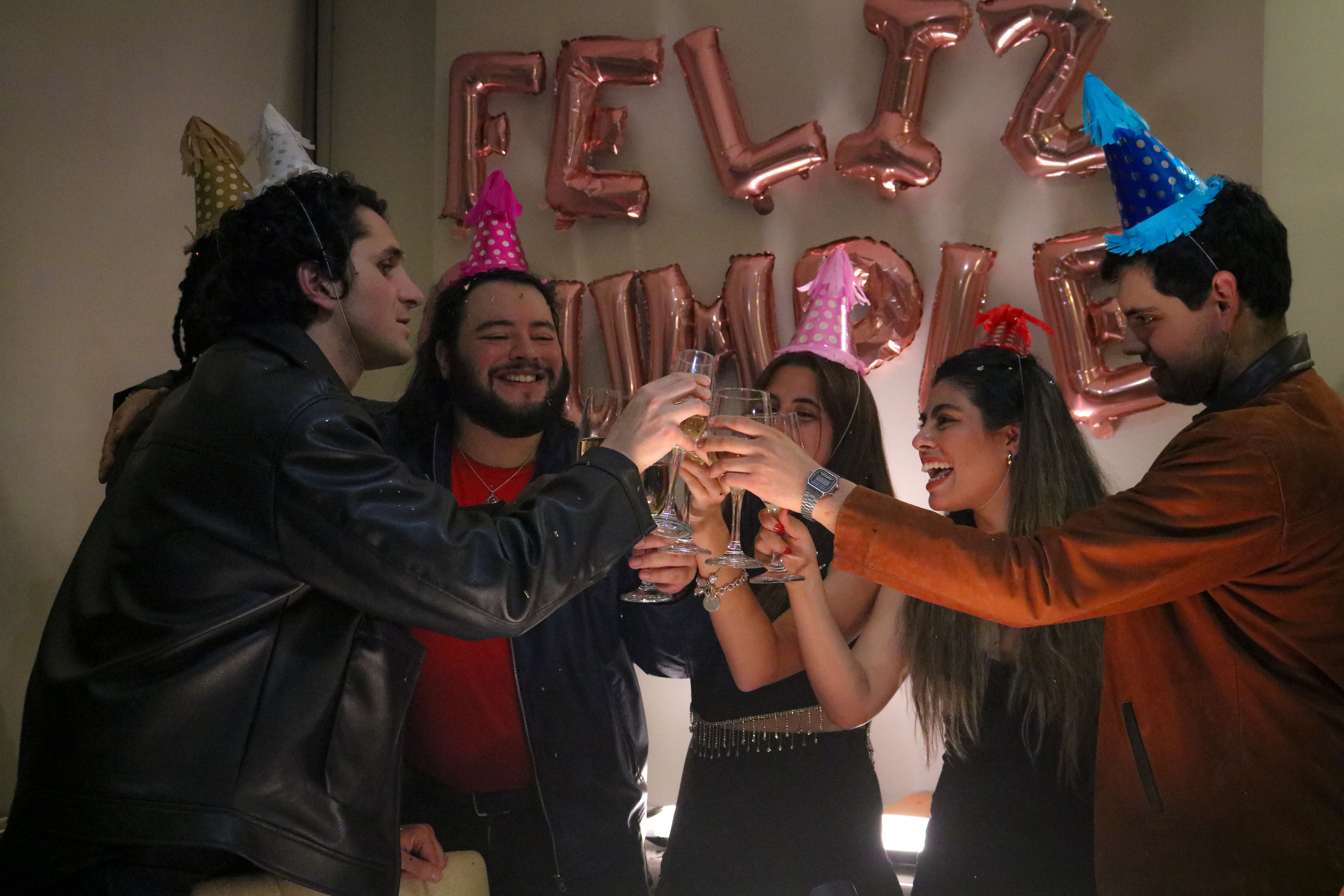 Friends raising their glasses together at a birthday celebration